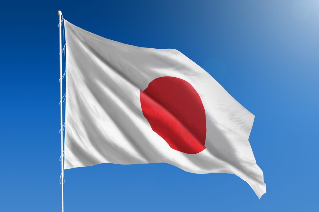 National flag of Japan on clear blue sky