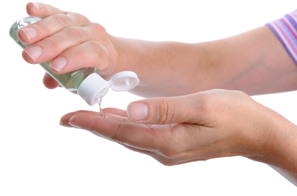 Woman Washing Hands with Alcohol Sanitizer